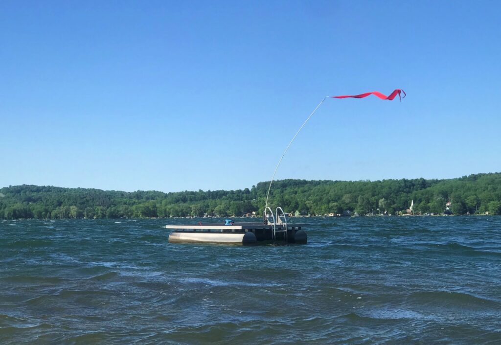 Flag flapping in the wind at Otisco Lake